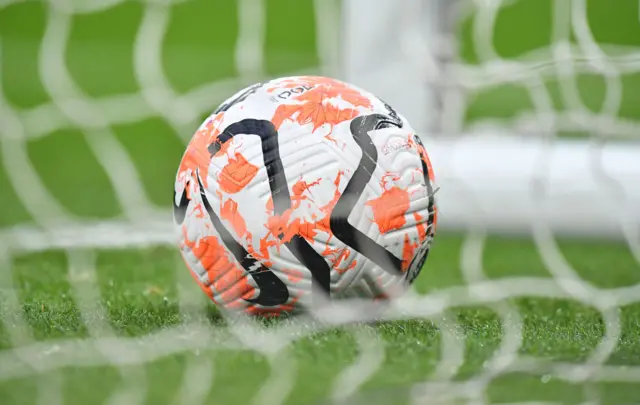 A match ball sits still in the net.