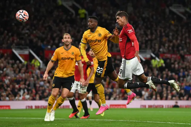 Varane rises highest to head the ball in to the net.