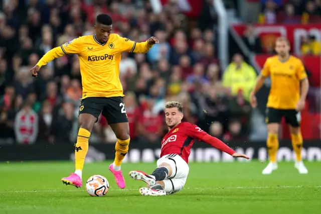 Semedo bursts forward past the sliding challenge of Mount.