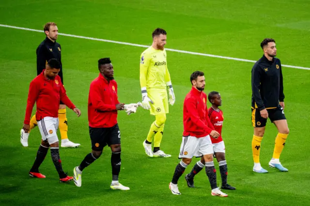 The players emerge onto the Old Trafford pitch.