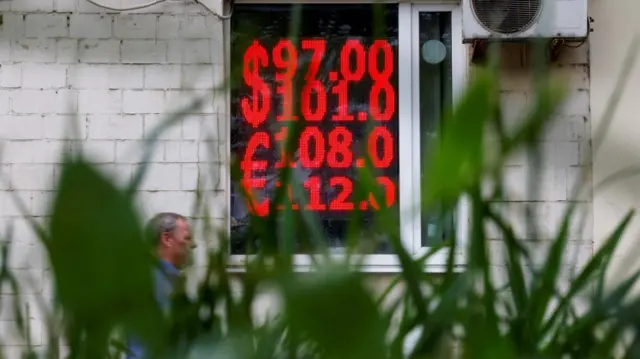 An electronic board in Moscow showing today's exchange rates