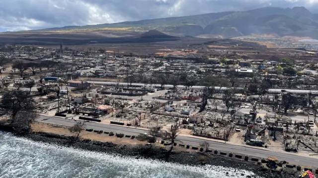 A view of the burned town of Lahaina on Maui, with the seafront and mountains around it visible