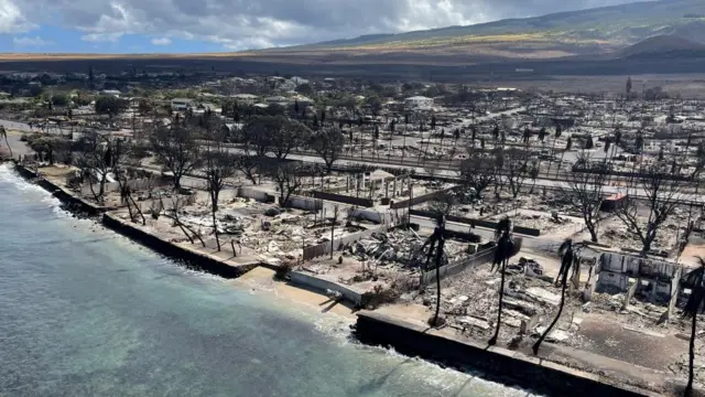 The shells of burned houses and buildings are left after wildfires in Lahaina