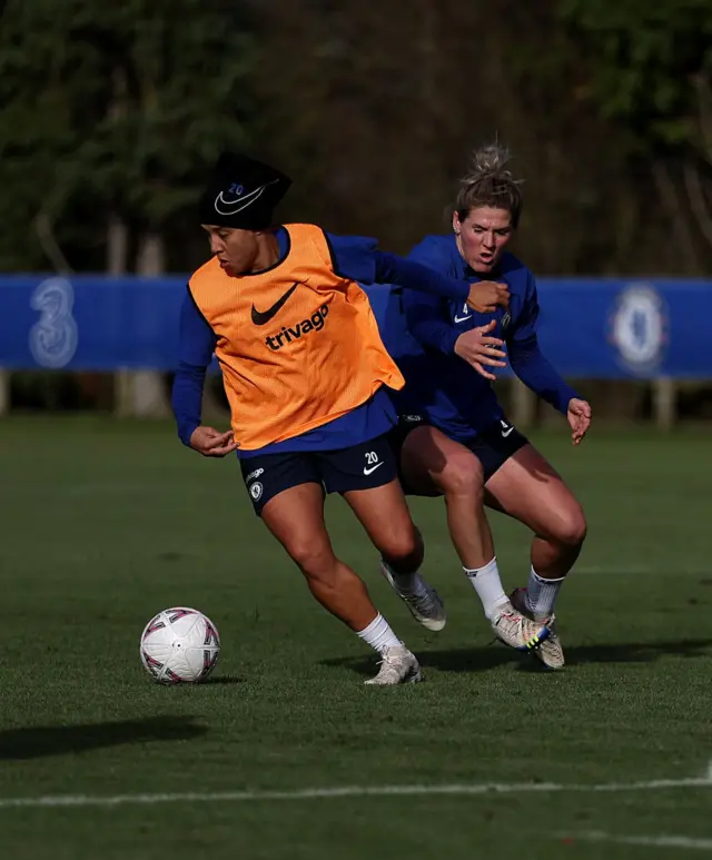 Sam Kerr dribbles away from Millie Bright in training.