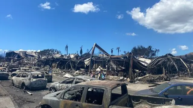 Burned cars, destroyed buildings and homes are pictured in the aftermath of a wildfire in Lahaina