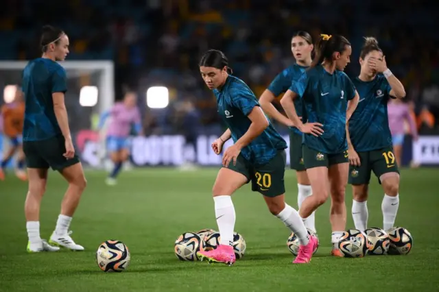 Sam Kerr leads the line of Matildas waiting to do shooting practice.