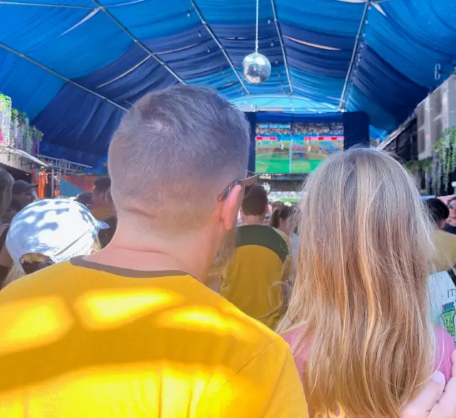 Australia fans watch on in a crowded bar.