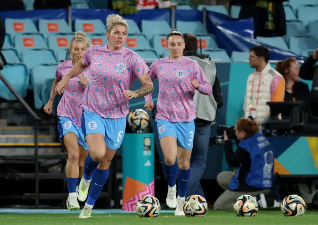 Millie Bright leads the England warm ups.