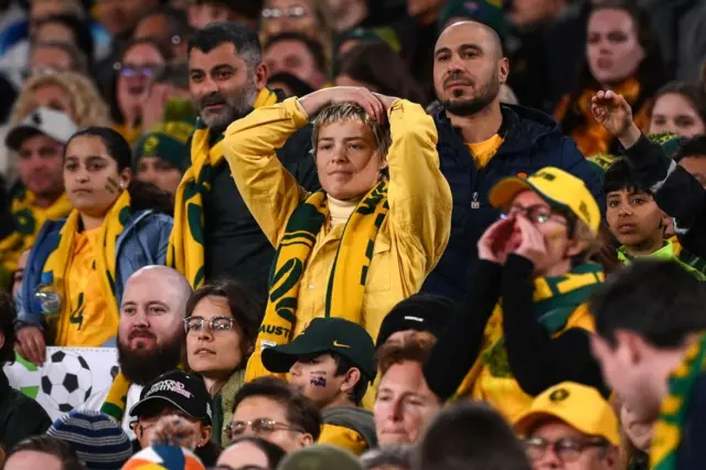 Australia fans hold their heads in their hands.