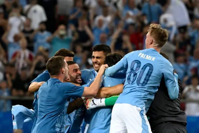 A group of Manchester City players celebrate