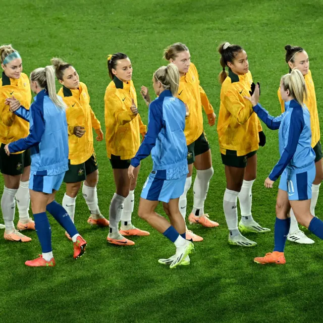 The teams shake hands ahead of kick off.