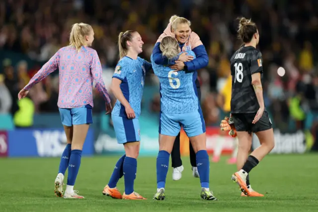 Millie Bright embraces Sarina Wiegman into a bear hug.