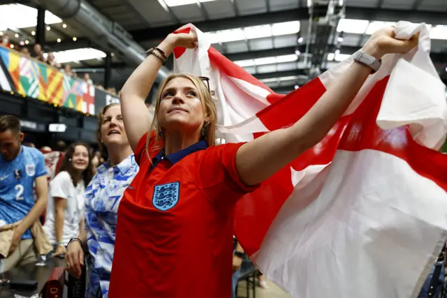 A fan waves a flag at box park.