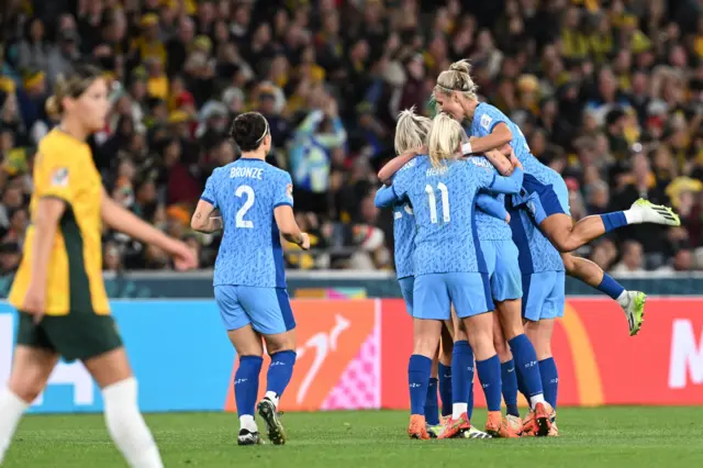 Hunt stands stunned as the Lionesses celebrate in the background.