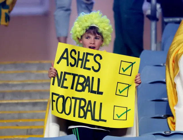 A fan with a sign referencing Australia's wins over England in other sports.