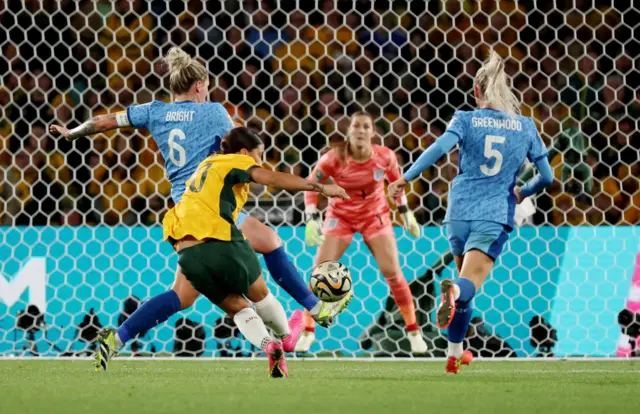 Sam Kerr strikes towards goal past Millie Bright.