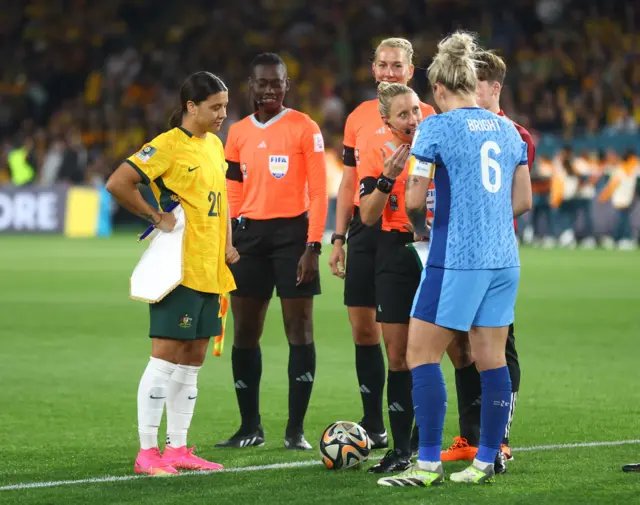 Sam Kerr and Millie Bright conduct the coin toss.