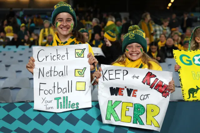 Your turn tillies and We've got Sam Kerr keep the king signs from young fans.