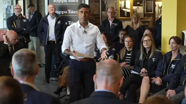 Rishi Sunak speaks to staff at Topps Tiles in Leicestershire