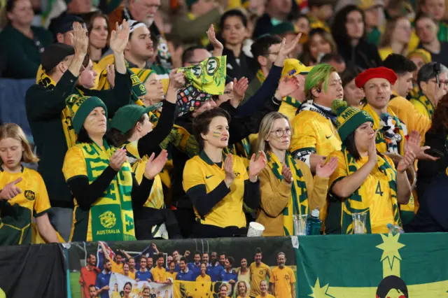 Australia fans clap and chant in support of the team.