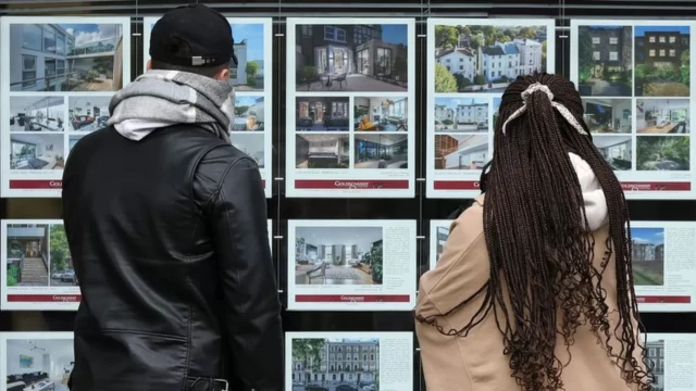 Couple looking at property window