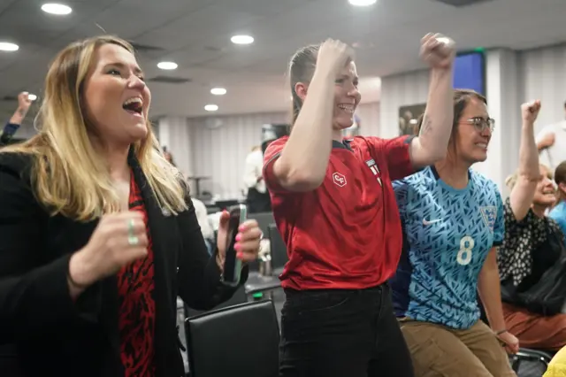 Office staff celebrate the the goal.