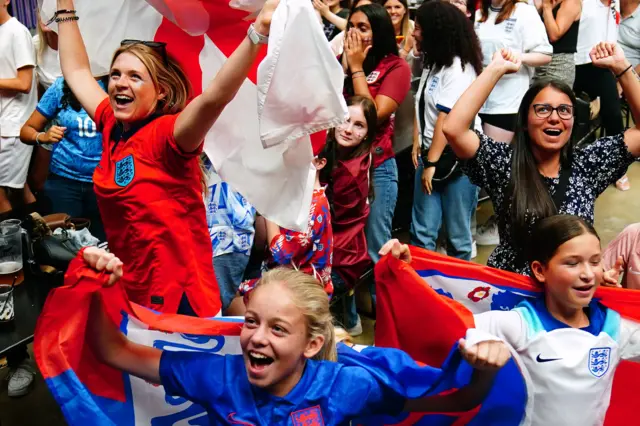 Fans at box park celebrate the goal.