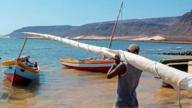 Fishermen getting ready to go fishing with traditional fishing boats near Baia das Gatas. Island Sao Vicente. Cape Verde