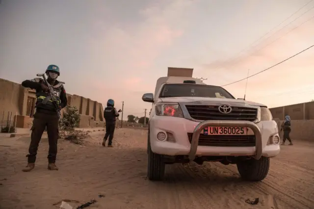 A UN policemenr escorts an armoured car of the United Nations Stabilisation Mission in Mali (MINUSMA), during a patrol in Timbuktu, on December 8, 2021