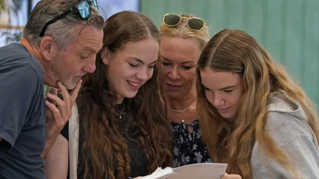 Lili Connell (second left) opens her A-level results with her parents at Brighton Girls school in Brighton, East Sussex