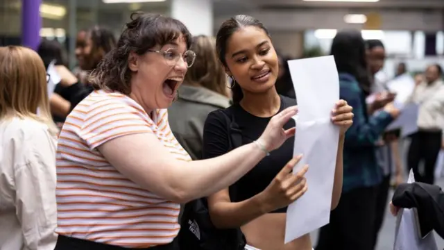 Student Maya Adams (R) of The City of London Academy in Southwark opens her A-Level results with her drama teacher Ms Young on August 18, 2022