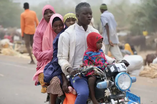 People travelling on a motorbike in Niger.