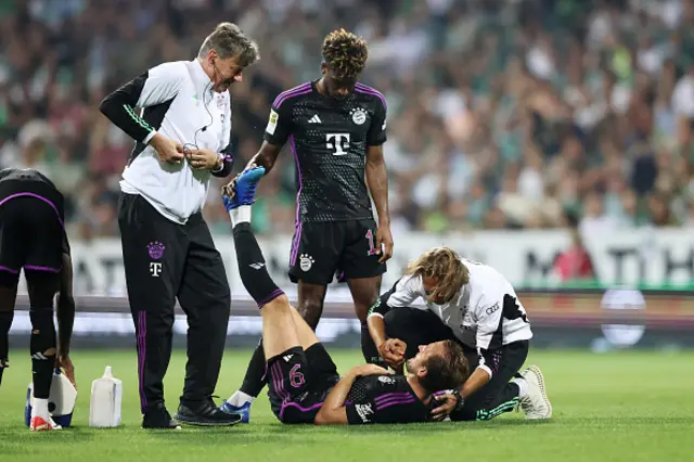 Harry Kane with physios on the pitch