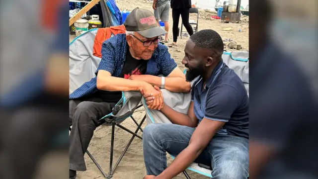 Kofi with a local resident in the community