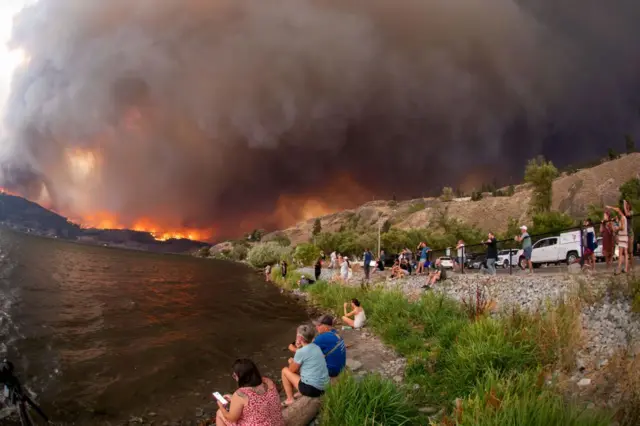 Residents watch the McDougall Creek wildfire in West Kelowna, British Columbia, Canada, on August 17, 2023,