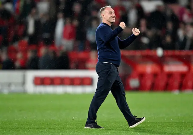 Steve Cooper with his arms aloft after the game