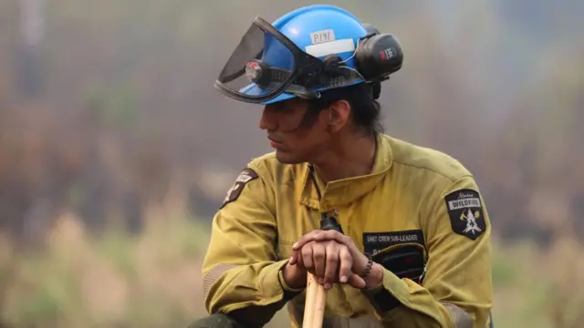 A firefighter in Sturgeon Lake Cree Nation, Alberta in June