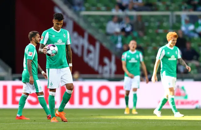 Werder Bremen players head to the centre spot after conceding last season