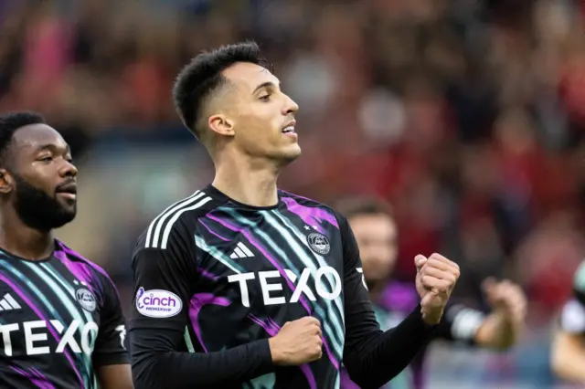 Miovski celebrates his opening goal in the 'Aurora' Aberdeen kit