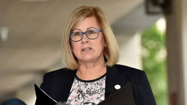 Family liaison officer Janet Moore reading the families' statement outside court