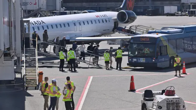 People disembark a plane