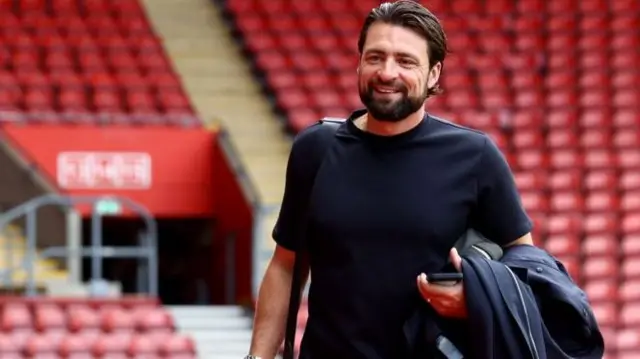 Southampton boss Russell Martin smiling as he enters St Mary's before a Championship game.