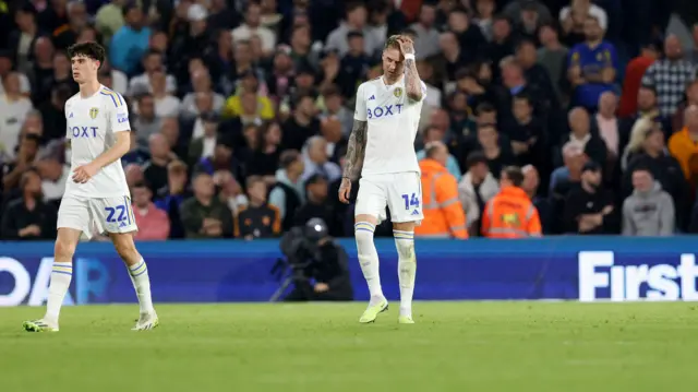 Joe Rodon (right) looks dejected after West Brom take the lead against Leeds