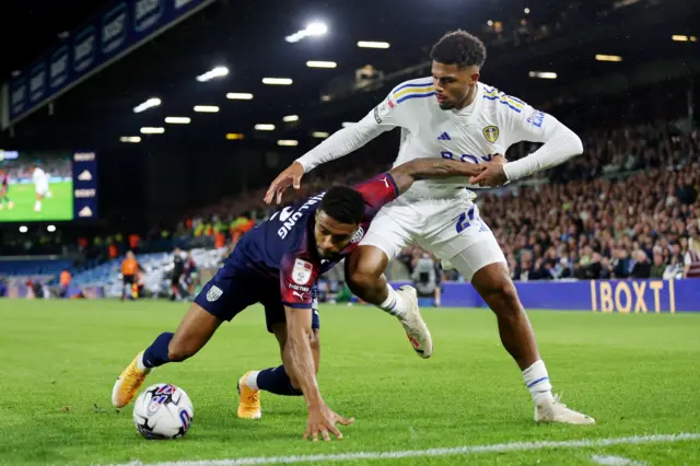 Darnell Furlong of West Brom is tackled by Georginio Rutter