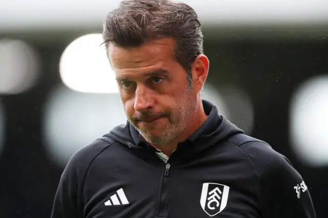 Marco Silva stares towards the floor.