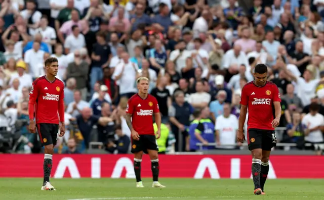 United players stand shellshocked after conceding a second goal.