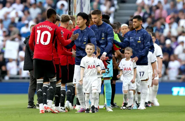 The players conduct the pre-match handshake.