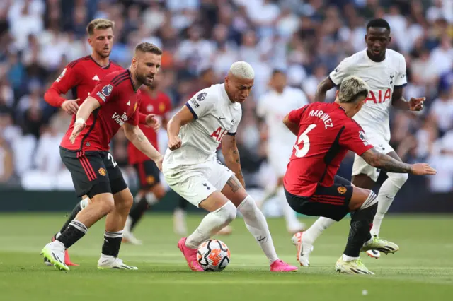 Richarlison is surrounded by United defenders.