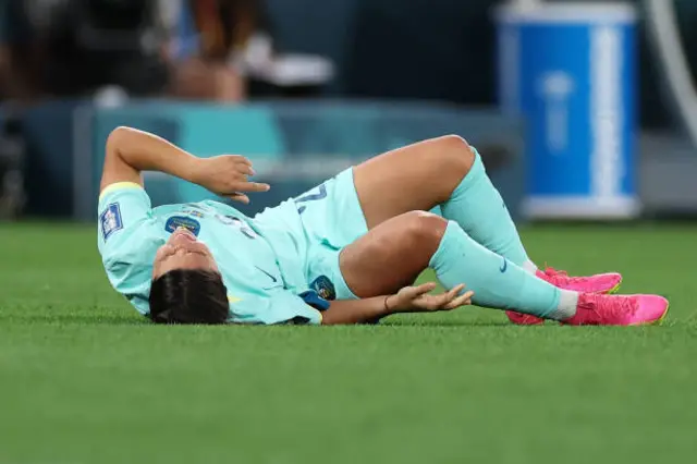 Sam Kerr lies on the pitch