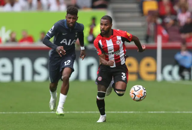 Rico Henry breaks down the wing with the ball, with Bissouma in pursuit.